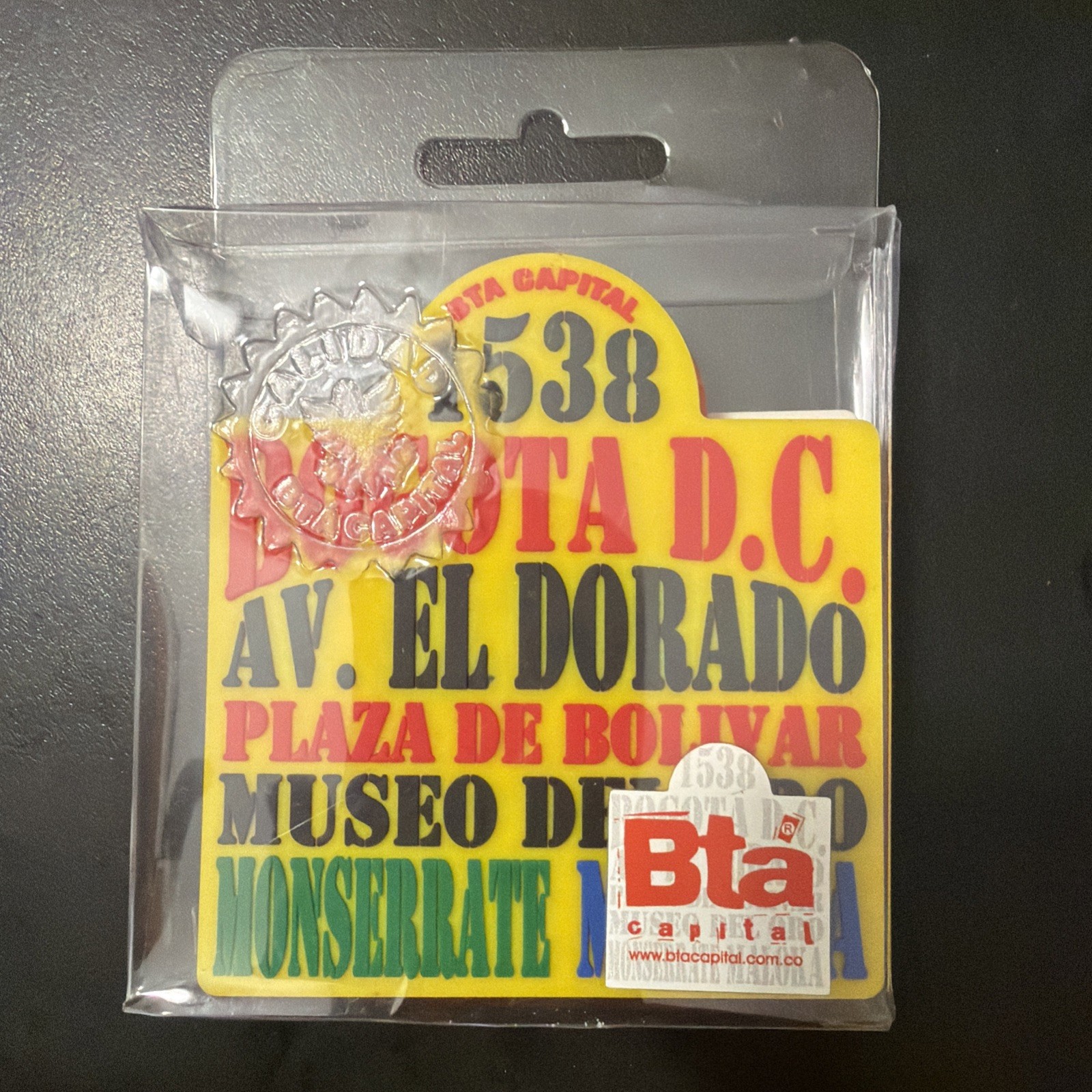 souvenir pin or coaster designed to look like a vintage Bogotá bus route sign,