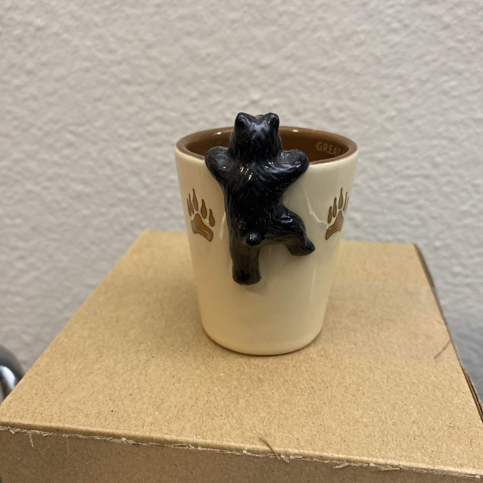 Yellowstone National Park black bear on rim with paw prints green ceramic shot