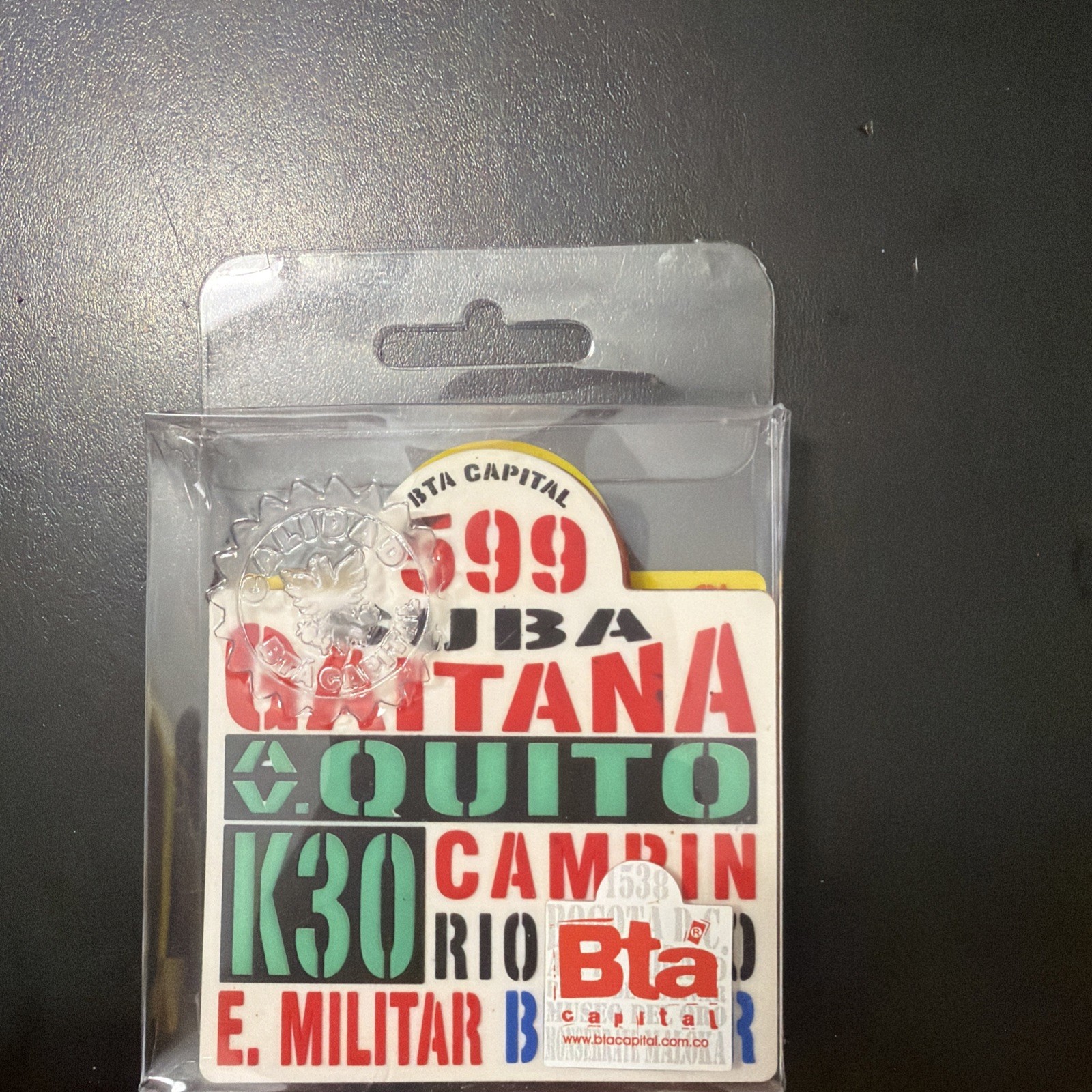 souvenir pin or coaster designed to look like a vintage Bogotá bus route sign,